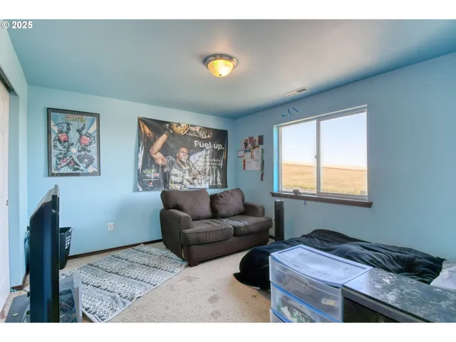 a bedroom with furniture and a window