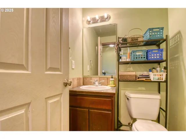 a bathroom with a sink a toilet and mirror