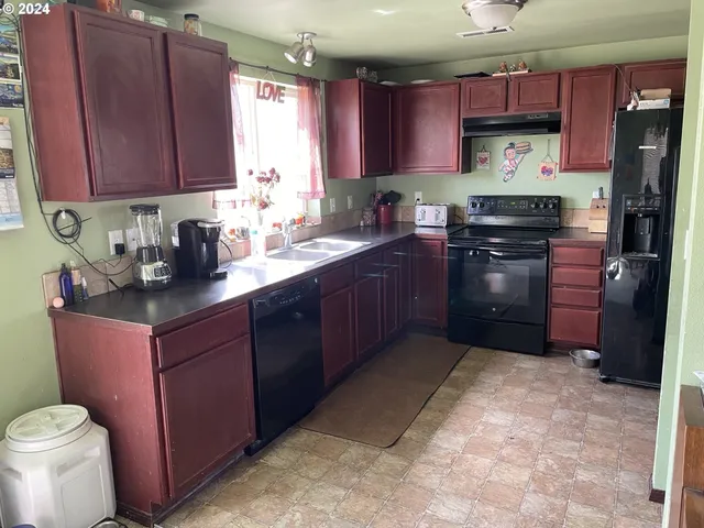 a kitchen with a sink stove and refrigerator