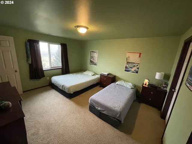 a bedroom with two beds and painted walls