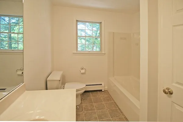 a bathroom with a bathtub and window
