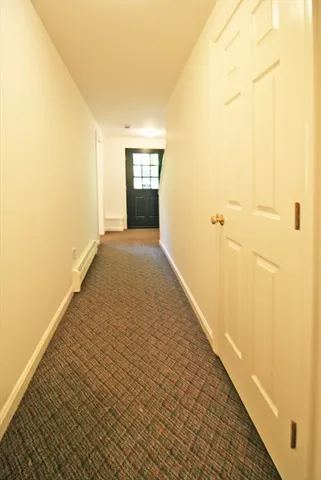 a view of hallway with wooden floor