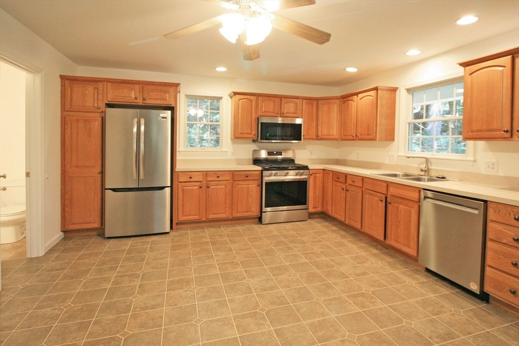36 Torrey Street Easthampton, MA 01027 - Photo 3 of 20 a kitchen with stainless steel appliances granite countertop a refrigerator a sink a stove a microwave and island