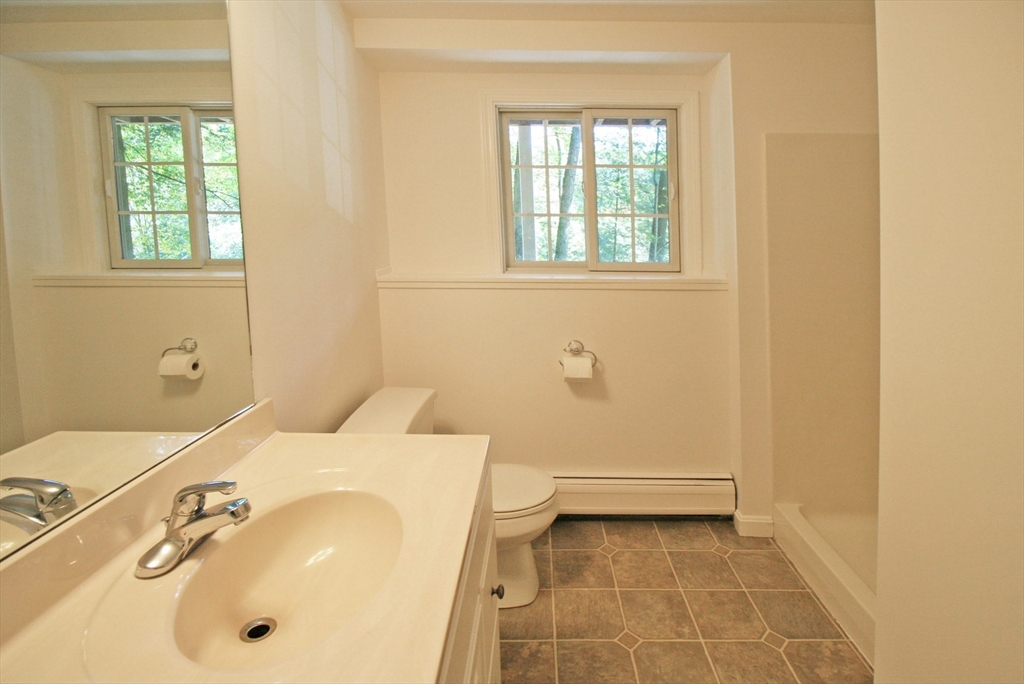 36 Torrey Street Easthampton, MA 01027 - Photo 10 of 20 a bathroom with a sink a toilet and a window