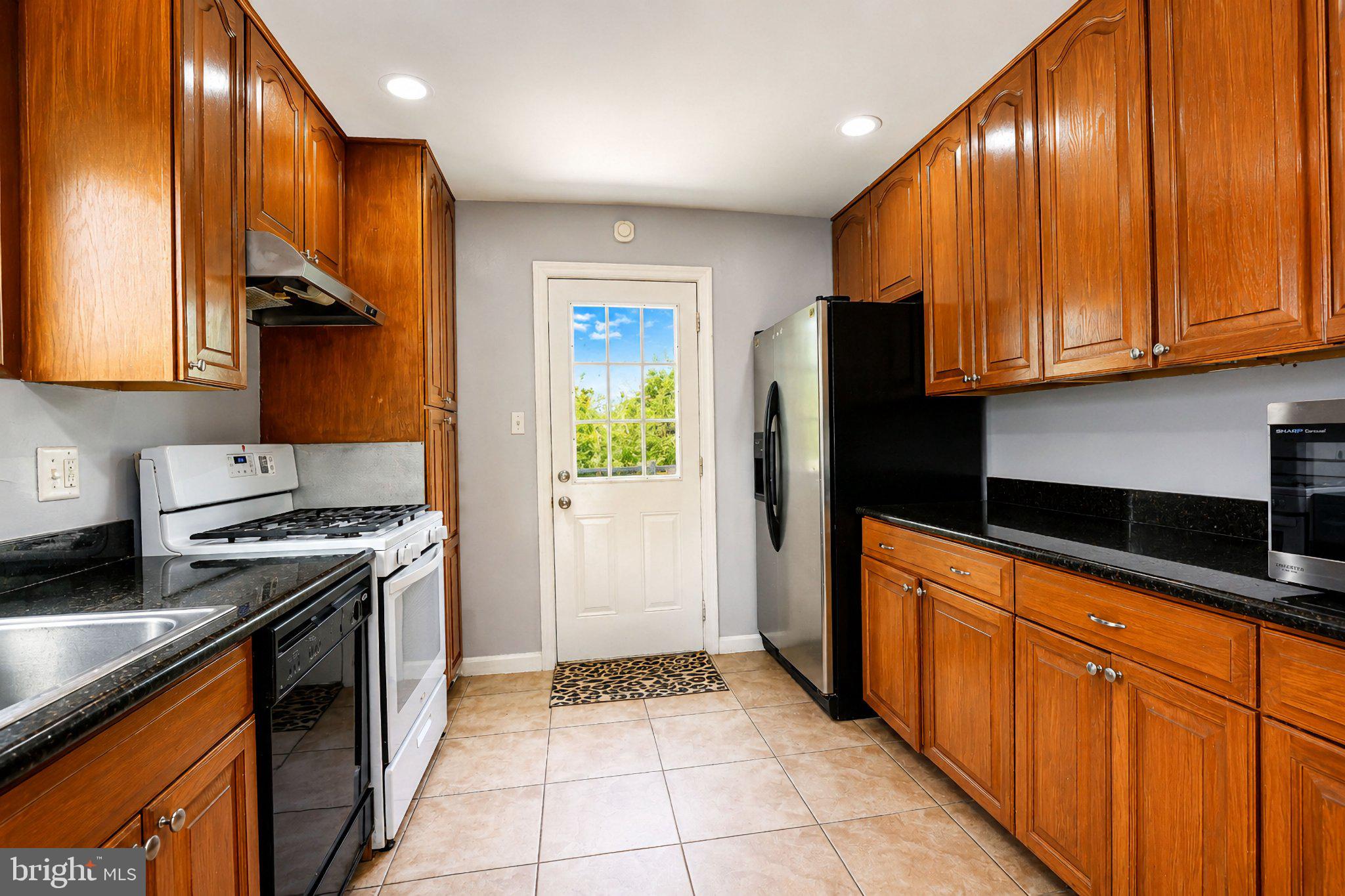 5712 Ash Drive Springfield, VA 22150 - Photo 10 of 38 Modern kitchen with warm wood accents.