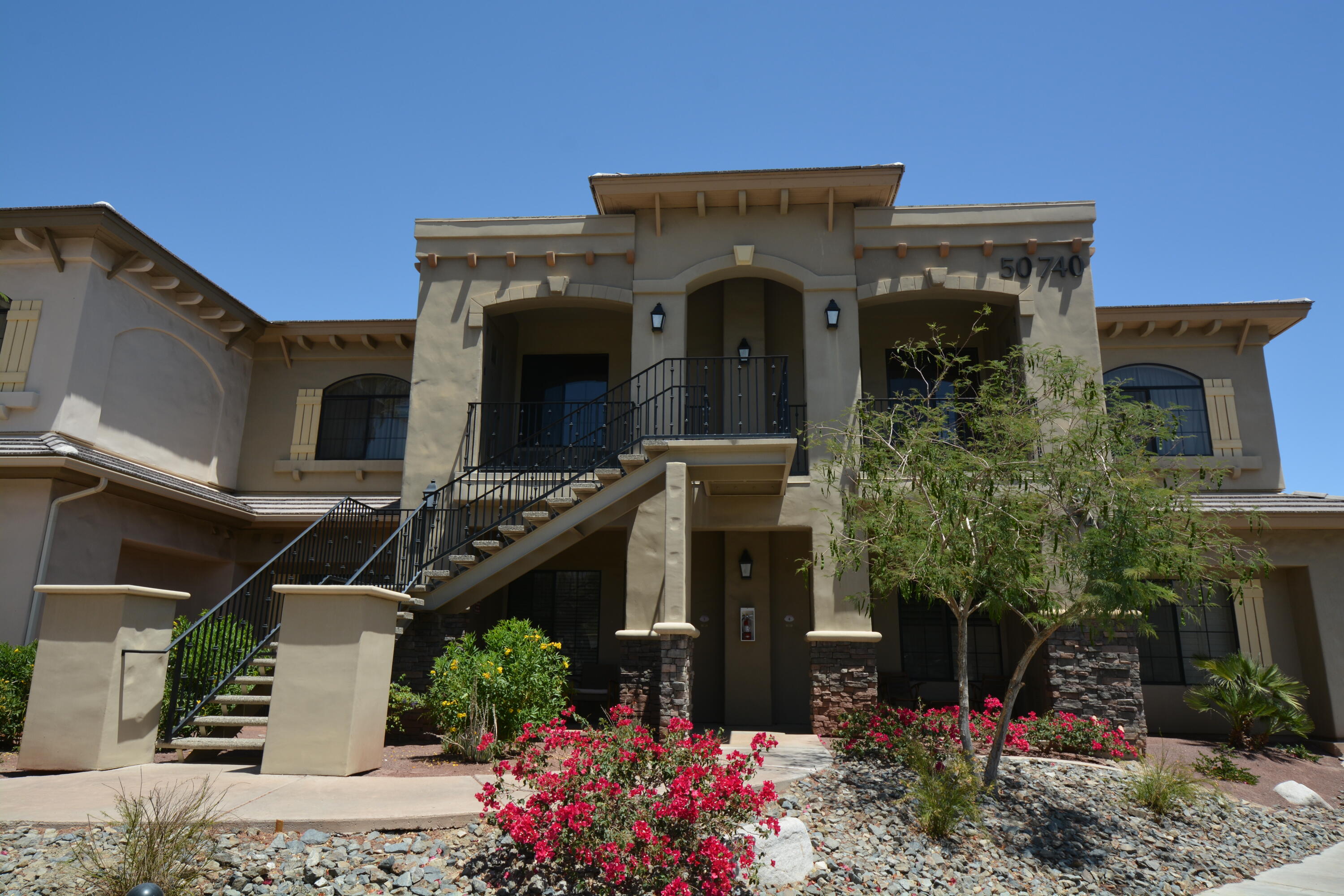50740 Santa Rosa Plaza, Unit 5 La Quinta, CA 92253 - Photo 3 of 17 a front view of a house with plants