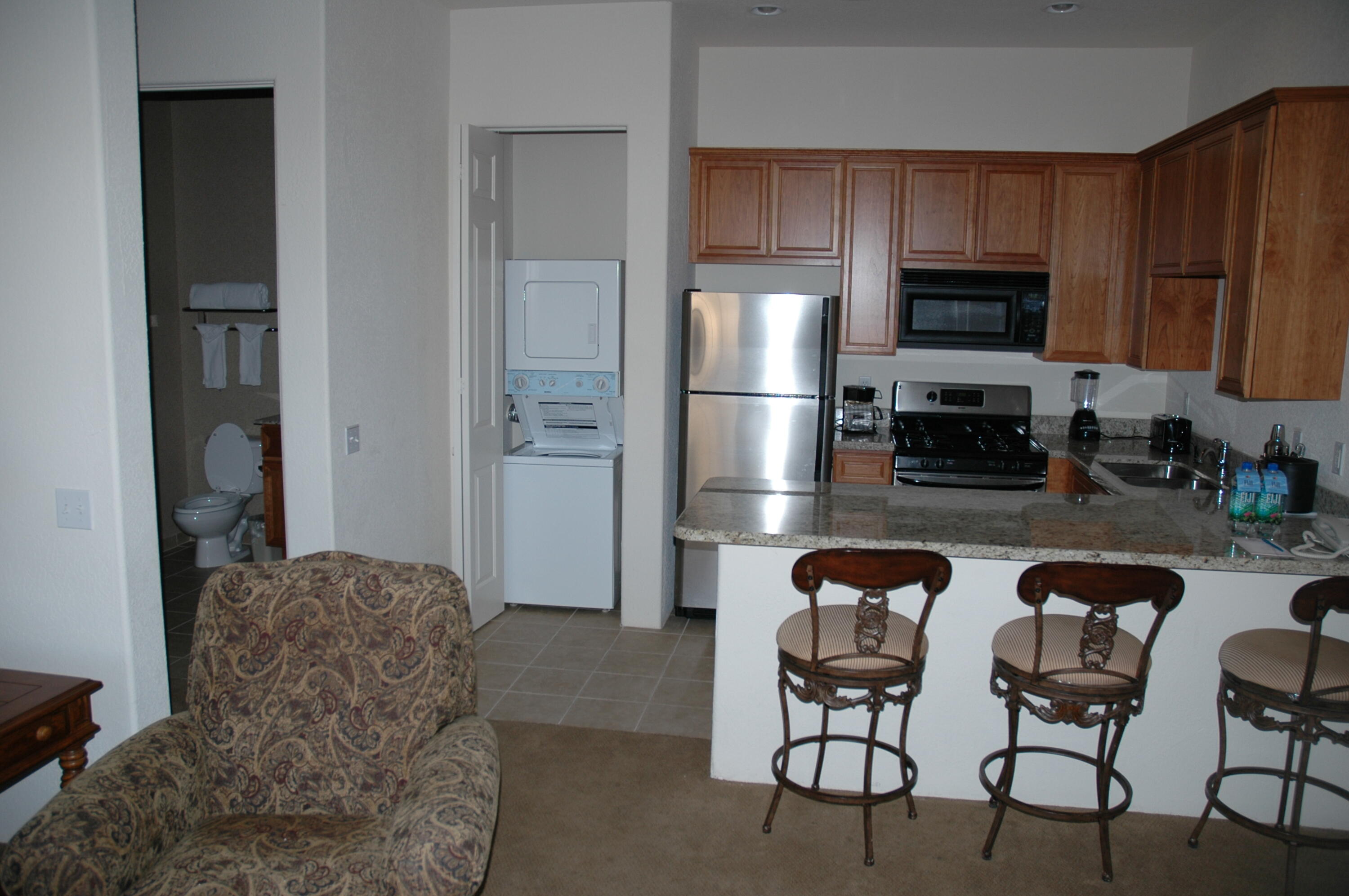 50740 Santa Rosa Plaza, Unit 5 La Quinta, CA 92253 - Photo 8 of 17 a kitchen with stainless steel appliances granite countertop a refrigerator and microwave