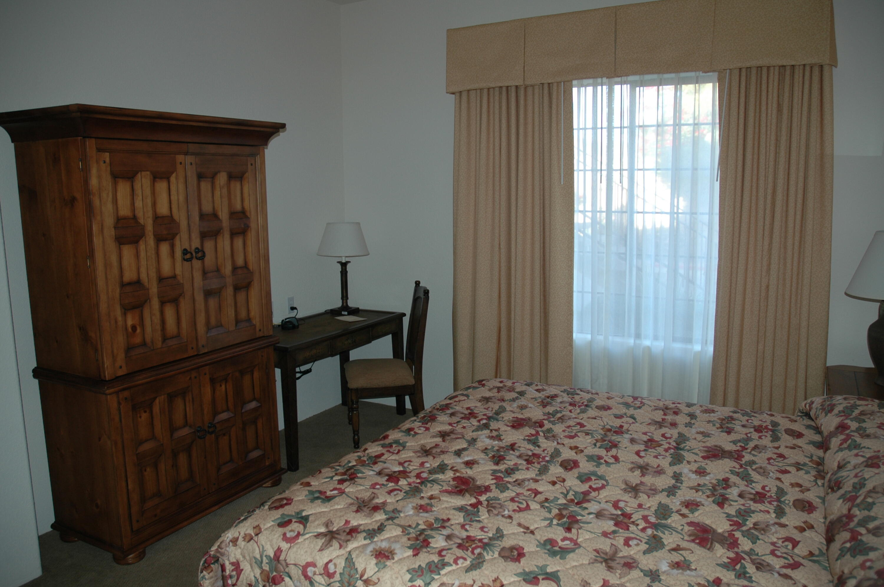 50740 Santa Rosa Plaza, Unit 5 La Quinta, CA 92253 - Photo 10 of 17 a bedroom with a bed and a window