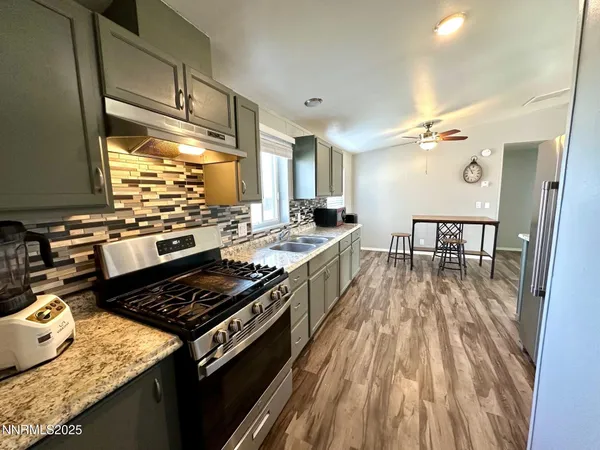 a kitchen with stainless steel appliances granite countertop a refrigerator and a sink