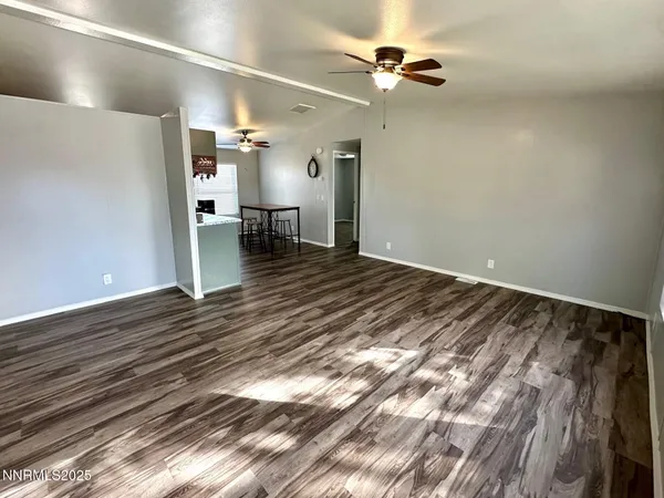 a view of a room with furniture and wooden floor
