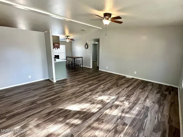 a view of a room with furniture and wooden floor