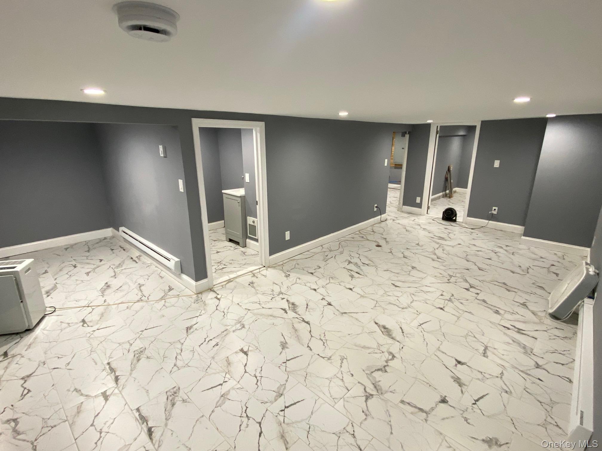 Undisclosed Address Mount Vernon, NY 10553 - Photo 17 of 20 a large bedroom with a bed and a mirror