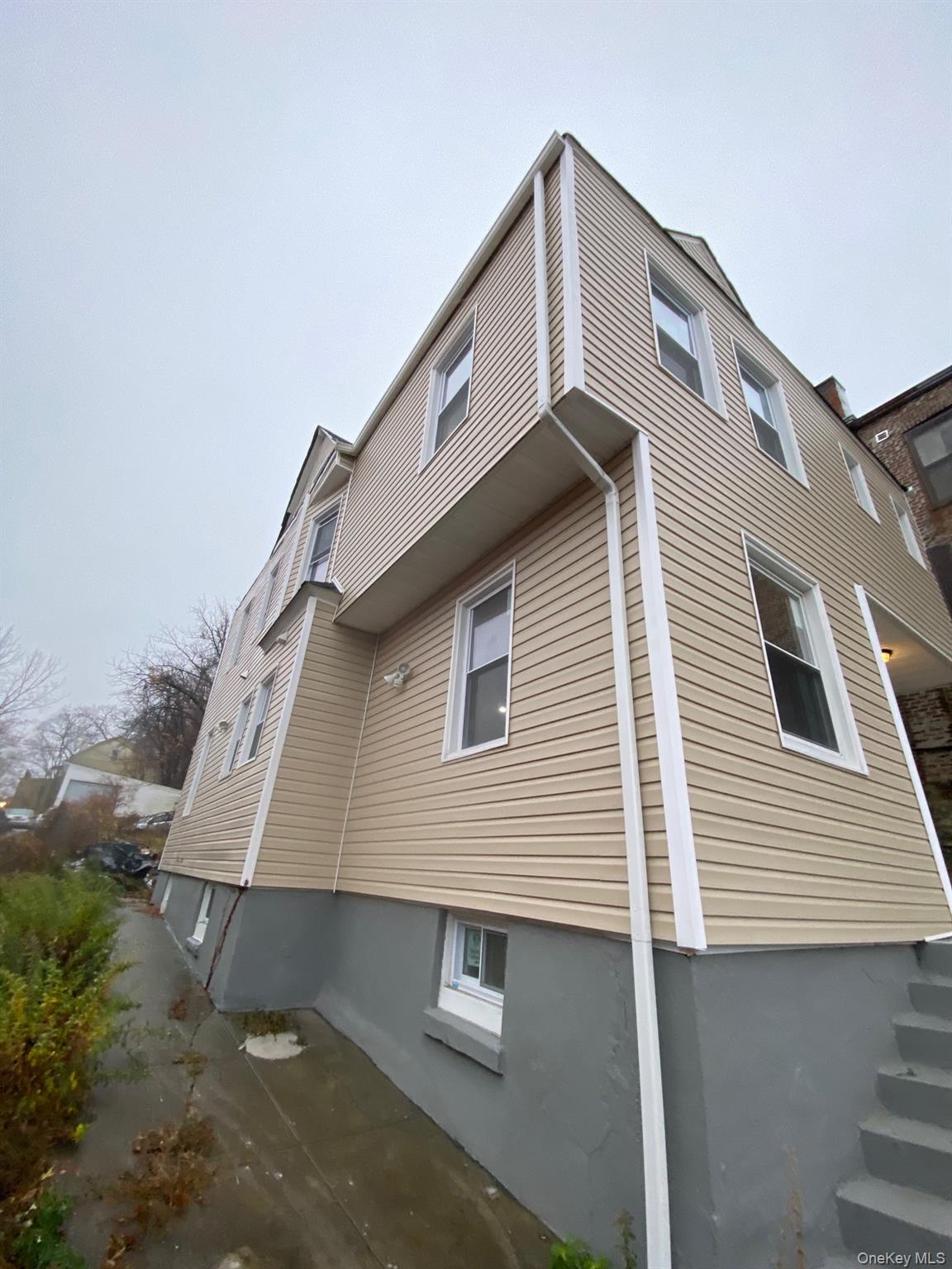 Undisclosed Address Mount Vernon, NY 10553 - Photo 2 of 20 a front view of a house with a garage