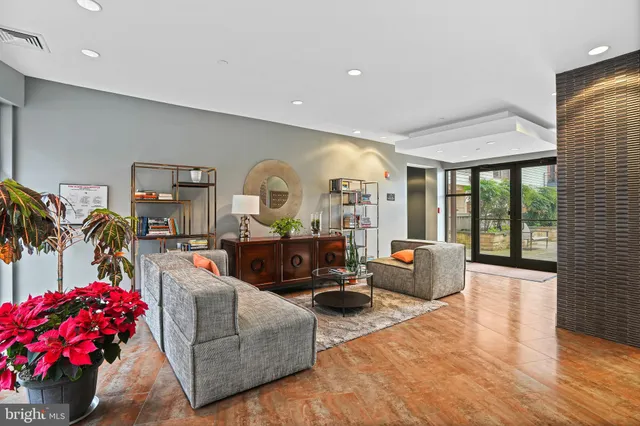a living room with furniture and a floor to ceiling window