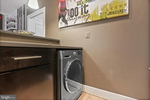 a close view of a utility room with dryer and washer