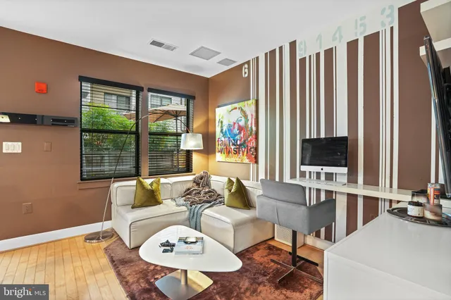 a living room with furniture and large windows