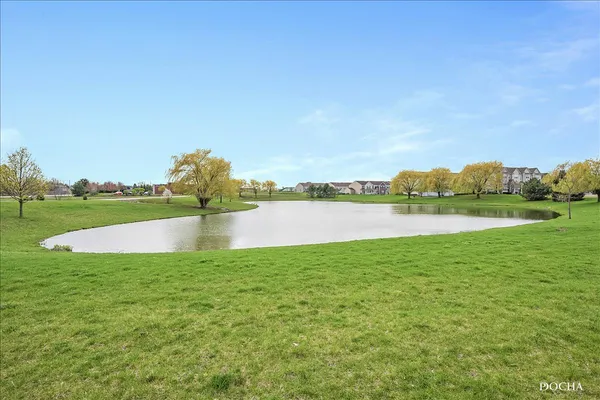 a view of a lake with houses in the back