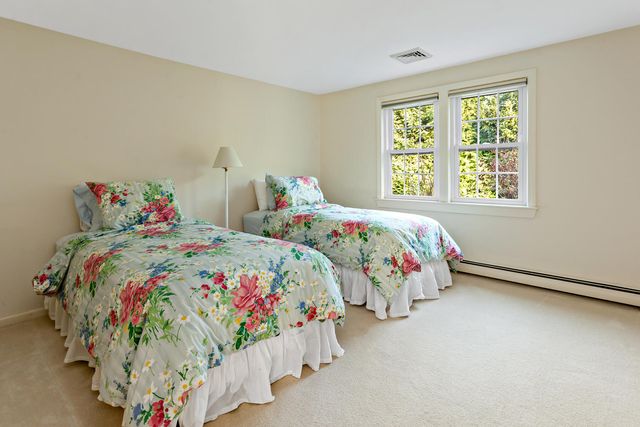 a bedroom with two beds and a window