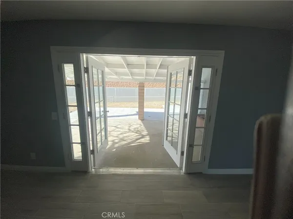 a view of an empty room and a window