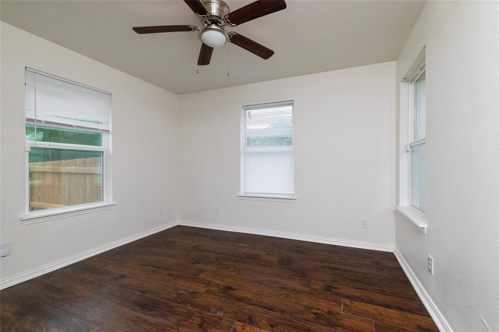 805 East Belt Line Road DeSoto, TX 75115 - Photo 10 of 15 a view of an empty room with wooden floor and a window
