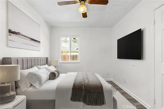 a bedroom with a bed and a flat screen tv