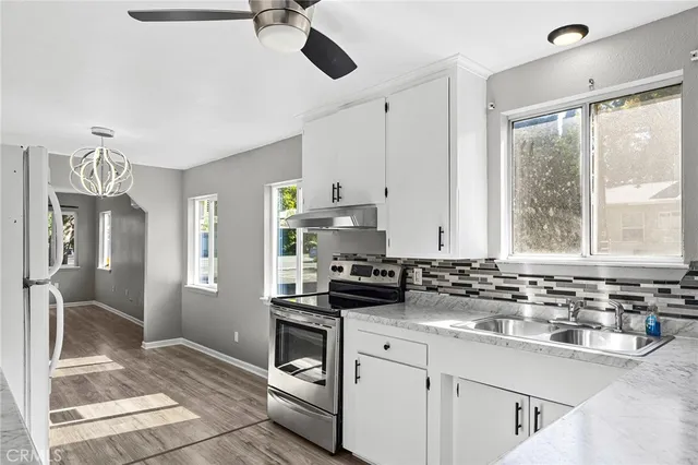 a kitchen with a sink stove and refrigerator
