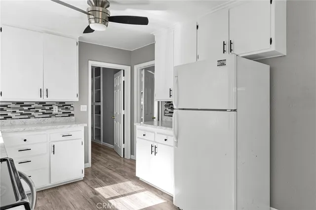 a kitchen with stainless steel appliances a refrigerator and cabinets