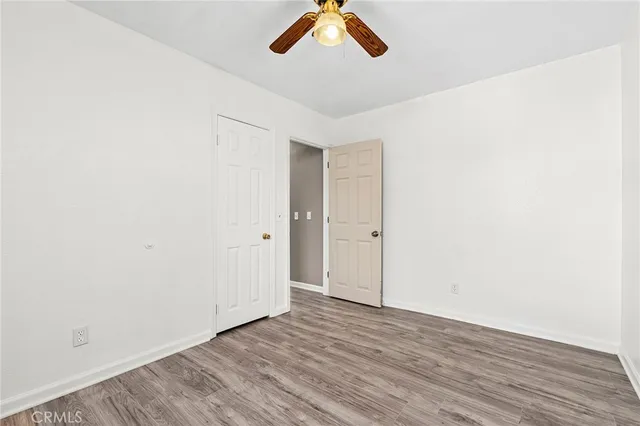 a view of a room with wooden floor