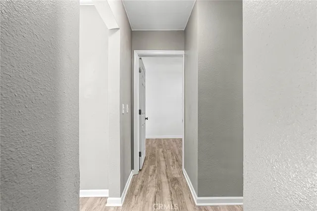 a view of a room with wooden floor