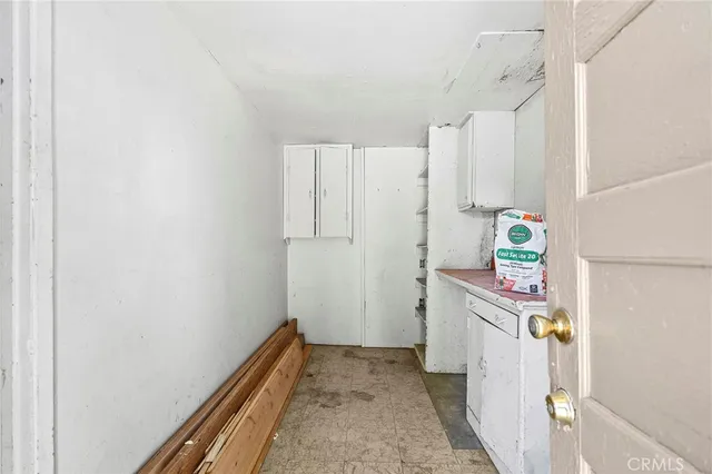 a hallway with sliding door and wooden floor