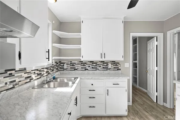 a kitchen with granite countertop a sink and a stove