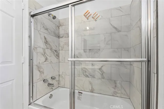 a bathroom with a shower and a glass door