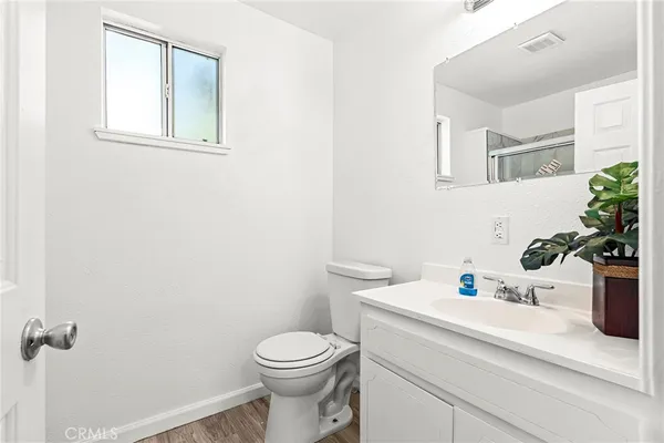 a bathroom with a sink a toilet and mirror