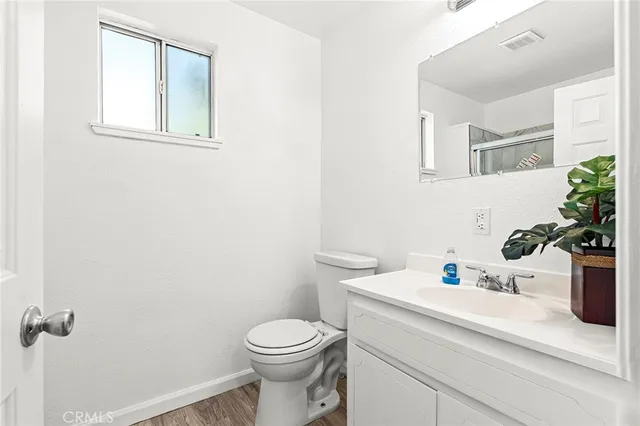 a bathroom with a sink a toilet and mirror