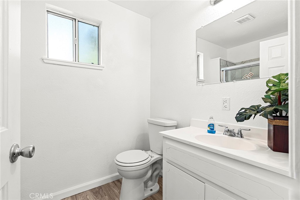 224 South Jackson Street Red Bluff, CA 96080 - Photo 8 of 44 a bathroom with a sink a toilet and mirror
