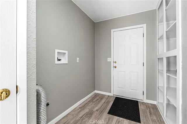 a view of a closet area with hardwood floor