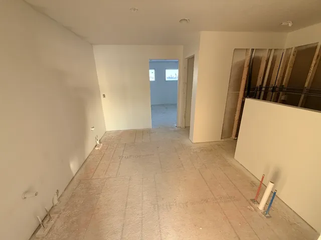 a view of hallway with stairs and wooden floor