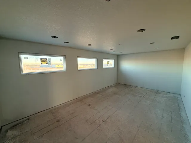 a view of an empty room with windows