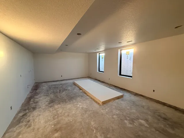 an empty room with a empty space and windows