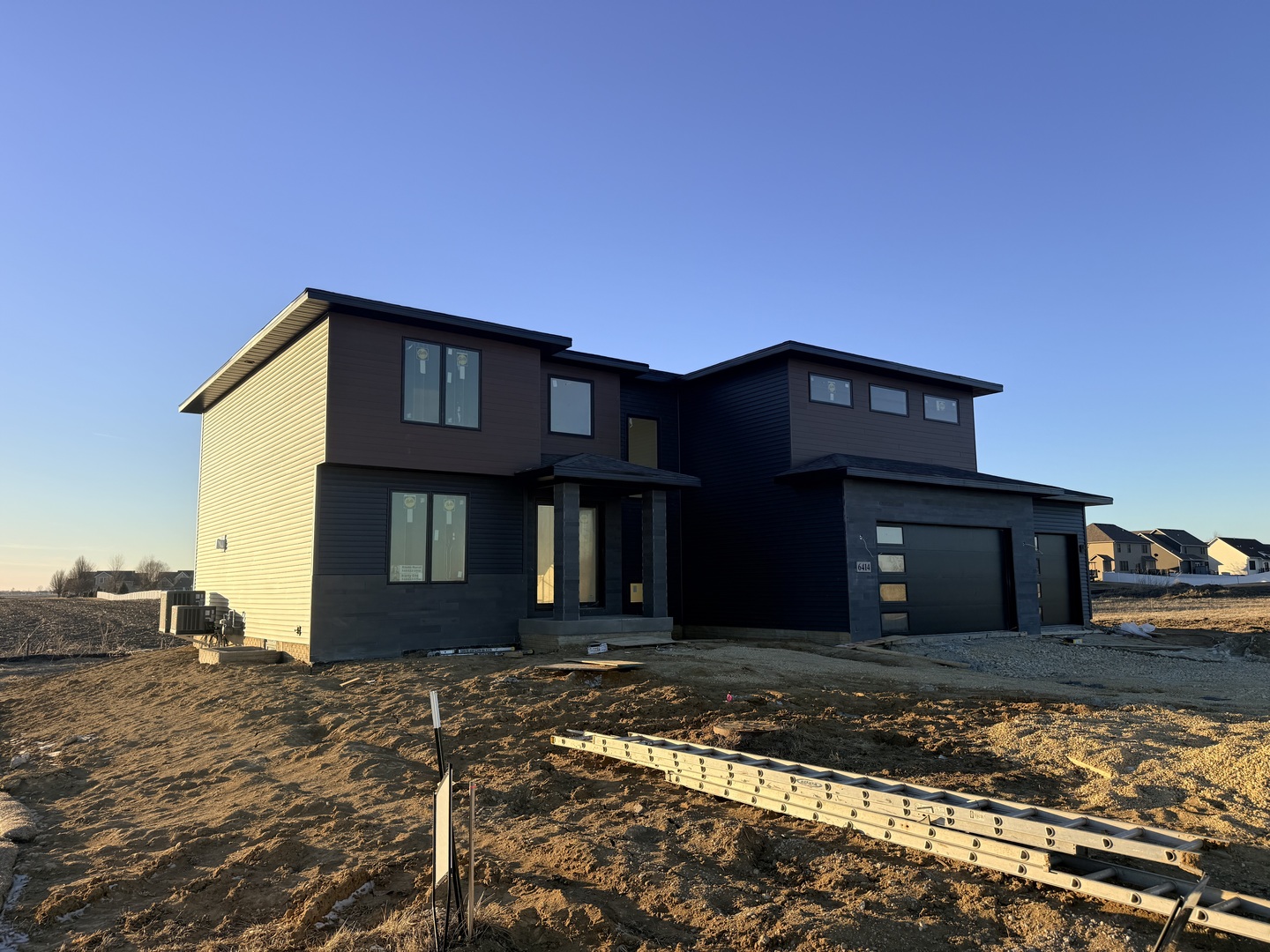 6414 Pelican Street Bettendorf, IA 52722 - Photo 2 of 57 a front view of a house with a yard