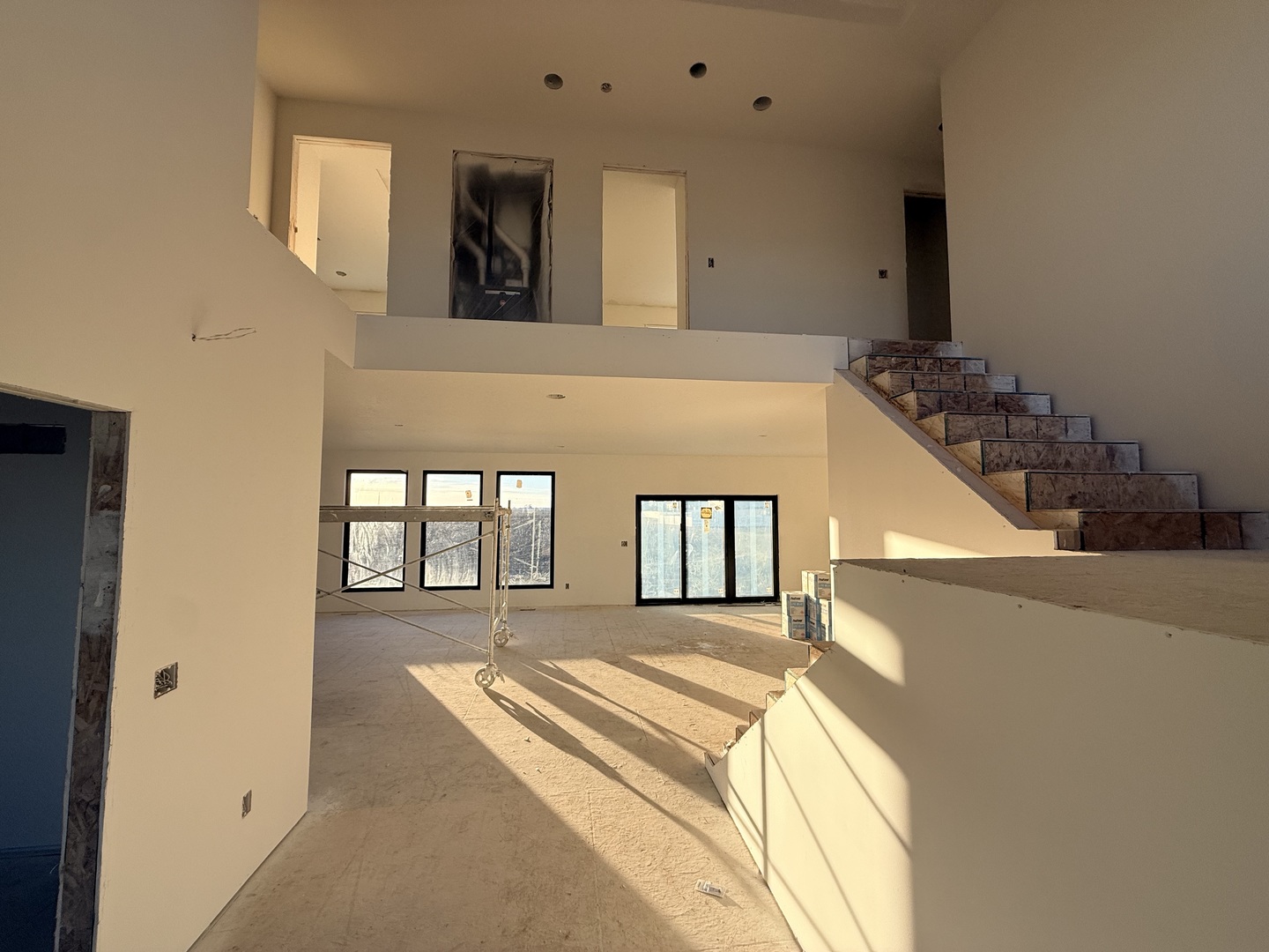 6414 Pelican Street Bettendorf, IA 52722 - Photo 3 of 57 a spacious bedroom with a large bed and a chandelier