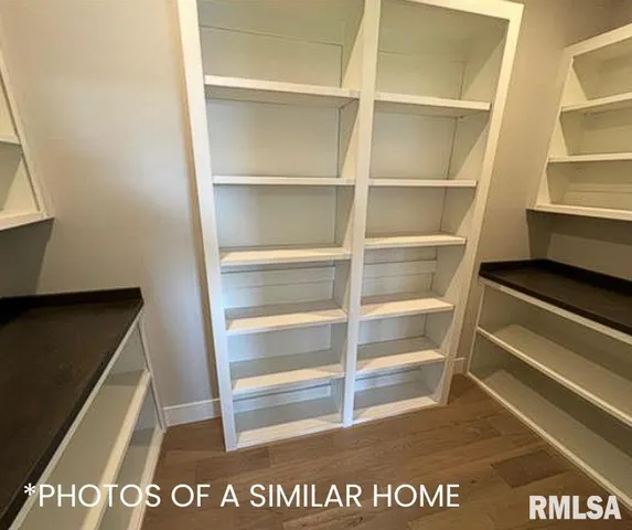 an empty room with windows and ceiling fan