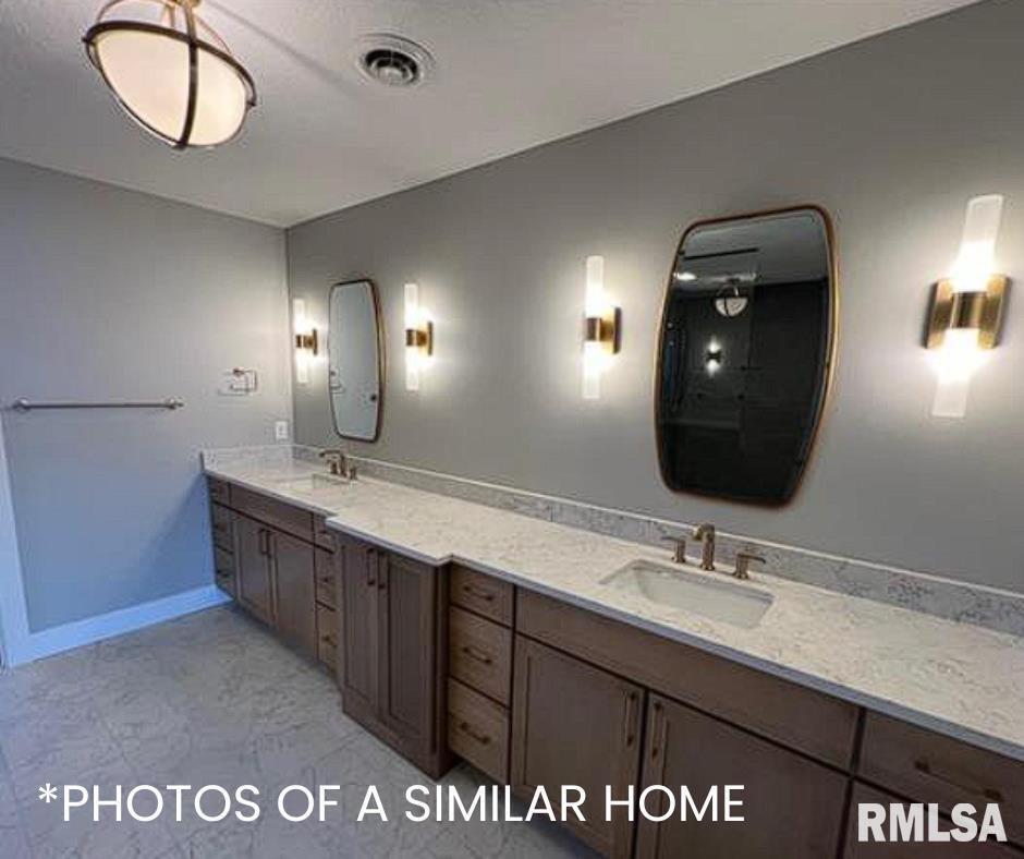 6414 Pelican Street Bettendorf, IA 52722 - Photo 40 of 57 a bathroom with a sink and a mirror