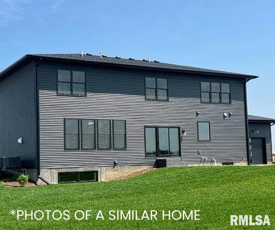 6414 Pelican Street Bettendorf, IA 52722 - Photo 57 of 57 a front view of a house with a garden