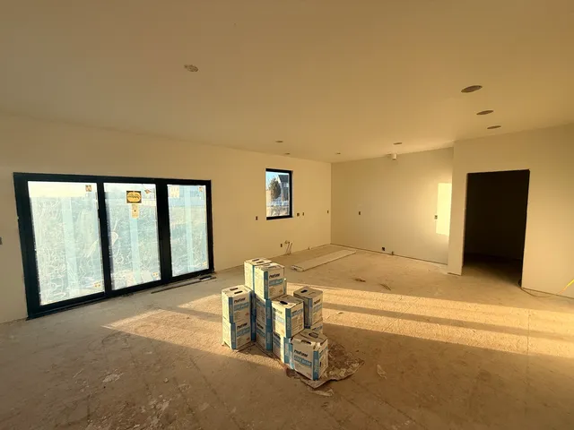 a spacious bathroom with a granite countertop sink and a bathtub