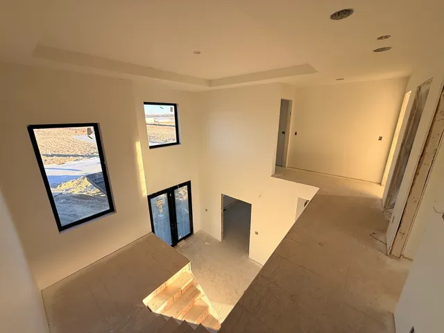 a view of an empty room and wooden floor