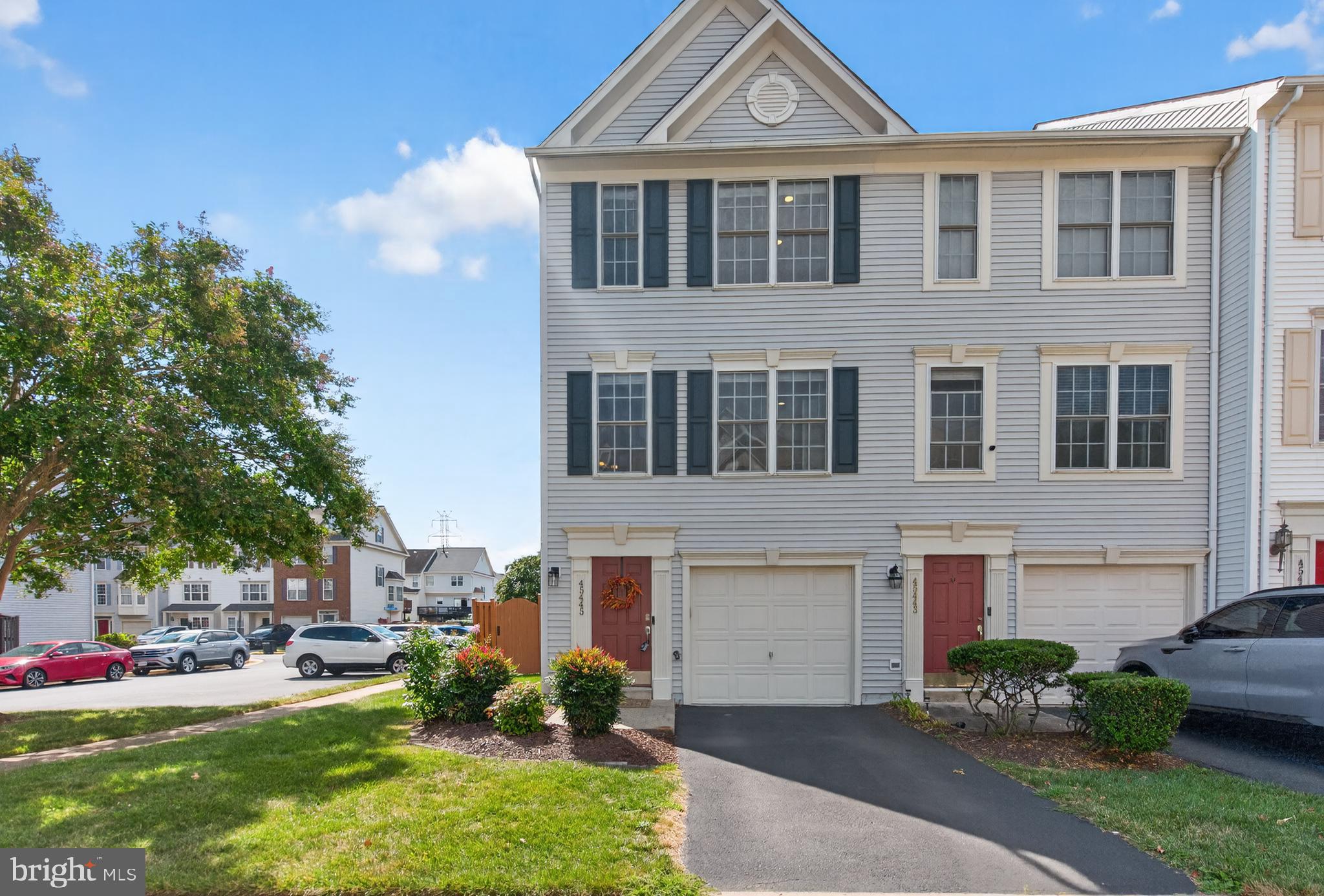 45445 Timber Trail Square Sterling, VA 20164 - Photo 2 of 38 a front view of a house with a garden and plants