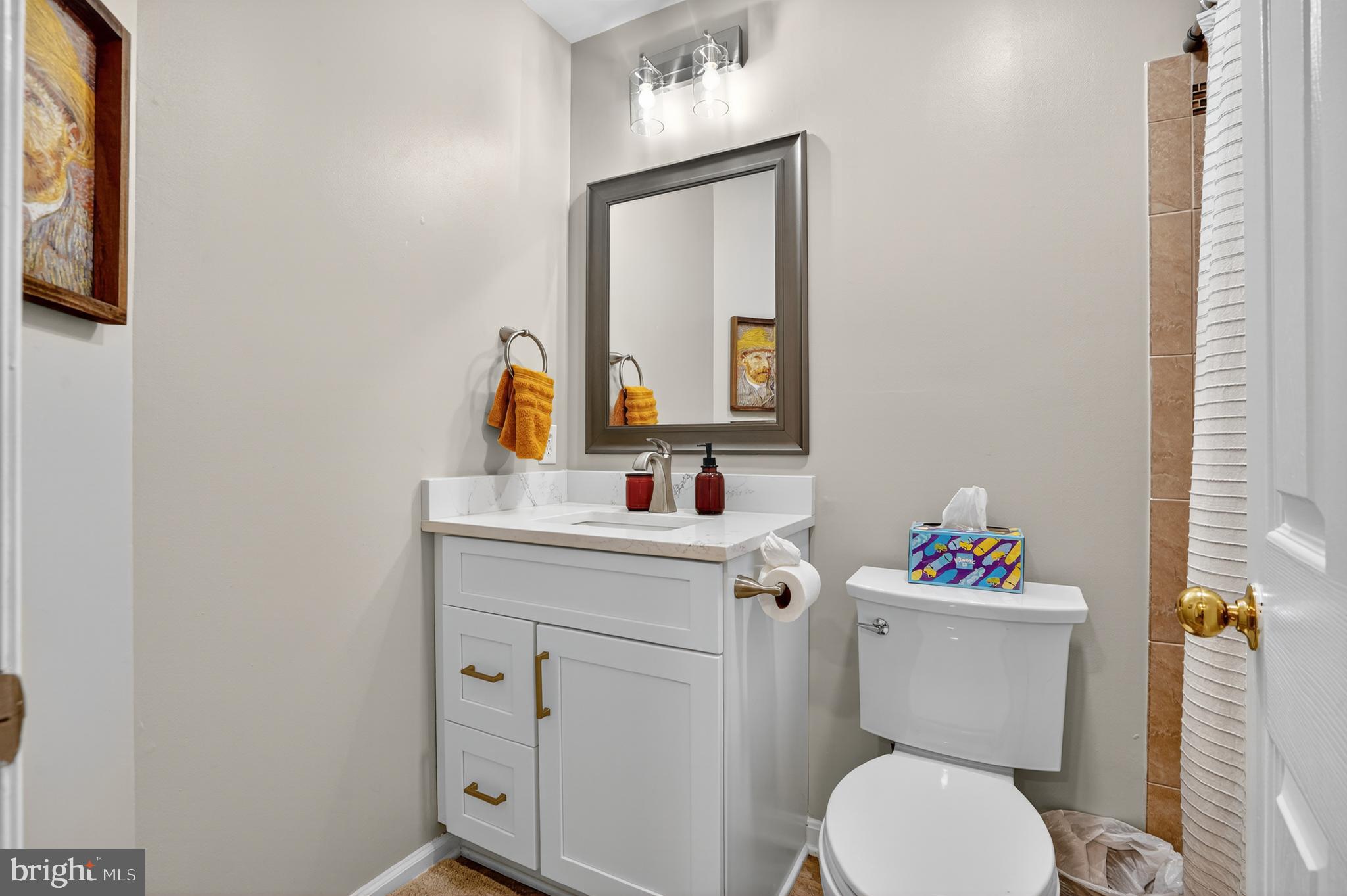 45445 Timber Trail Square Sterling, VA 20164 - Photo 21 of 38 a bathroom with a toilet sink vanity and mirror