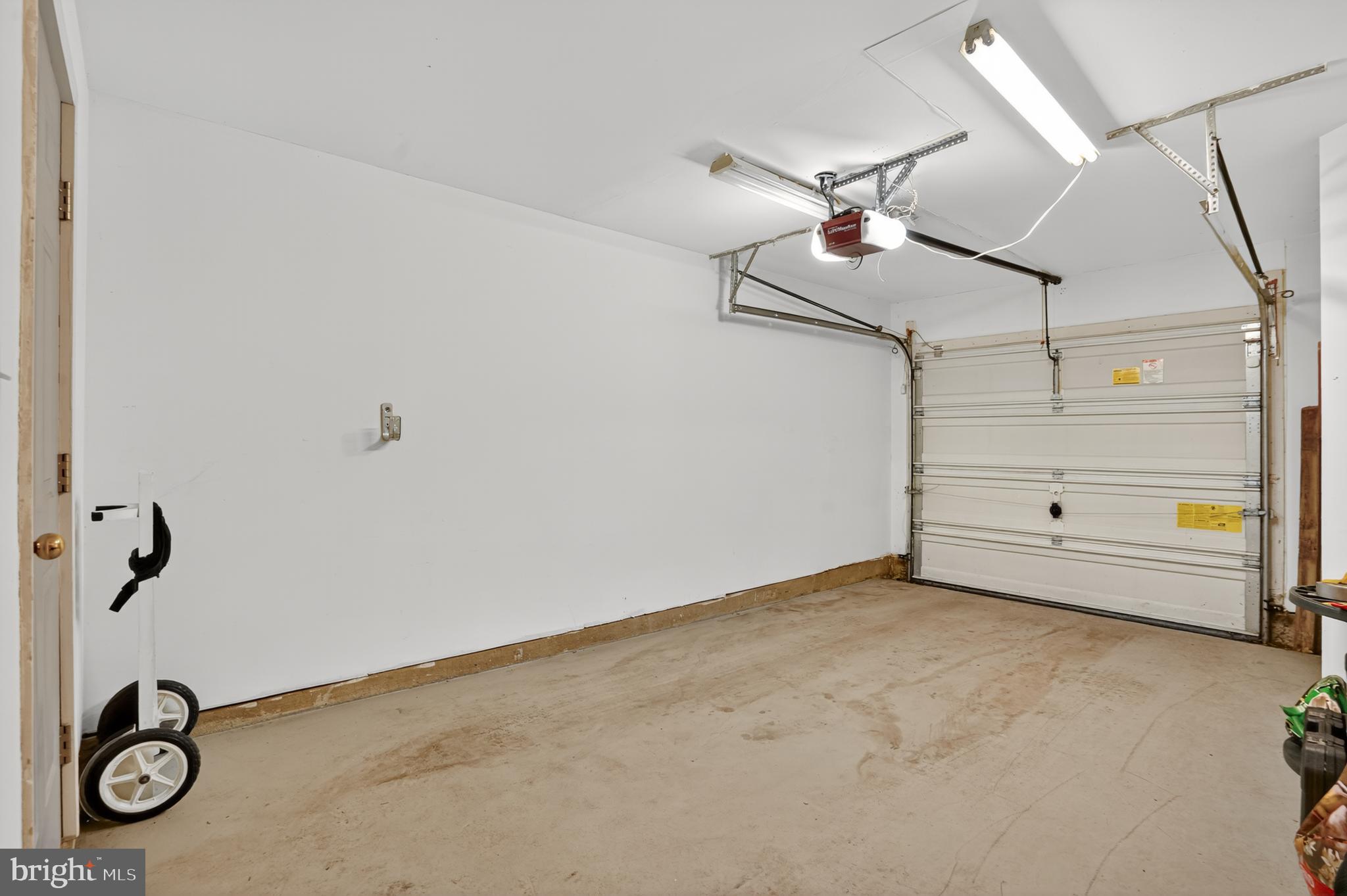 45445 Timber Trail Square Sterling, VA 20164 - Photo 26 of 38 a view of a garage with air conditioner and a ceiling fan