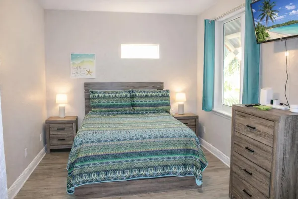 a bedroom with a bed and a window